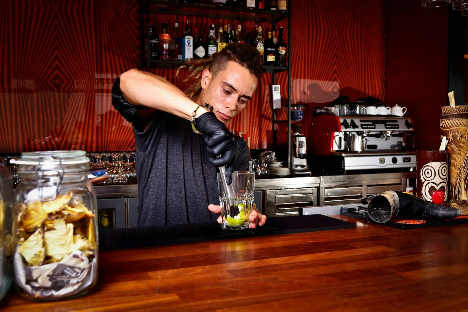 a man in a bar making a drink